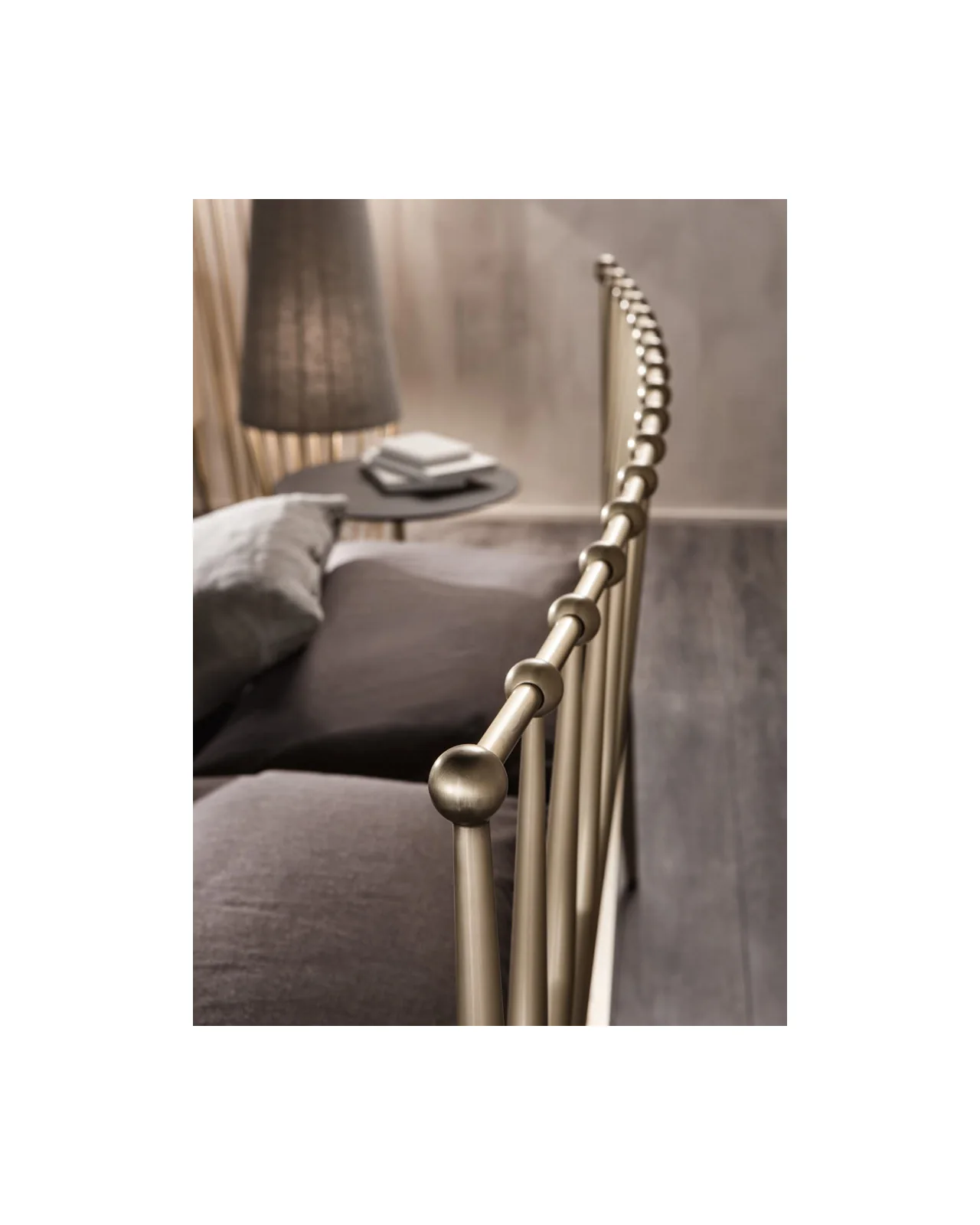 Metal bed rail with round finials beside a nightstand, Italian furnishings for Rome homes
